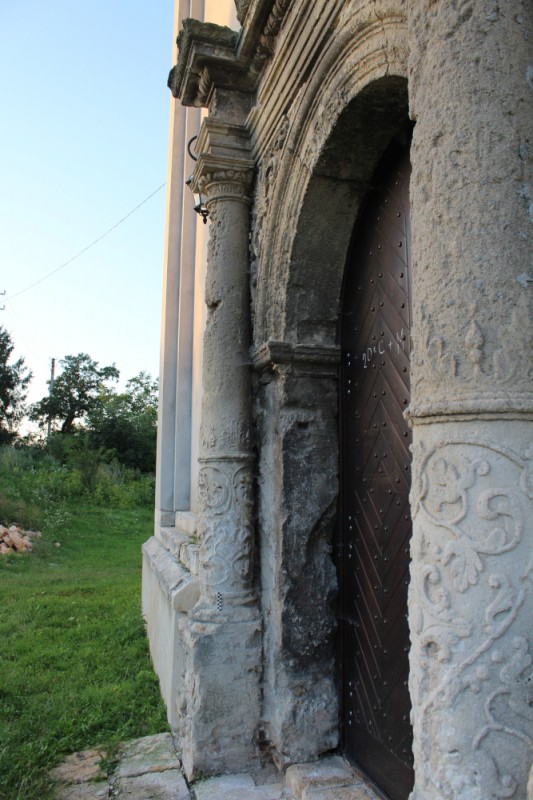 Entrance portal of the parish church of the Assumption of the Virgin Mary in Būšėnai, Ukraine, 17th century before restoration