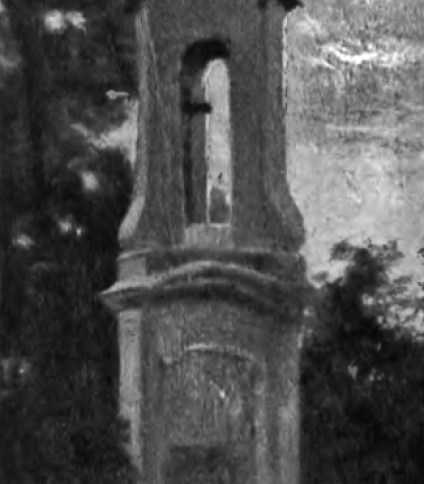 Posąg św. Jacka w Wilnie, z wysoką kolumną, na której szczycie znajduje się figura. Konstrukcja otoczona drzewami i drewnianym płotem.