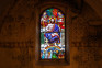 Fotografia przedstawiająca Stained glass window \"Christ the Judge\" by Józef Mehoffer in the Saint-Martin church in Onnens