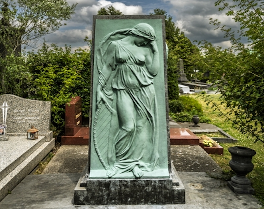 Bronze relief of Muse Euterpe on Józef Wieniawski's tombstone at Ixelles Cemetery, Brussels. The figure is draped in flowing garments, holding a musical instrument.