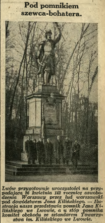 Photograph from 1936 showing the monument of Jan Kiliński in Lviv. The statue stands on a pedestal surrounded by trees. A group of people is gathered at the base of the monument.