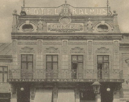 Historyczna pocztówka przedstawiająca Hotel Kalmus w Złoczowie, 1918. Na fasadzie widnieją napisy po polsku: 'Hotel Kalmus', 'Cafe Excelsior' i 'Restauracya Kawiarnia Hotel'.