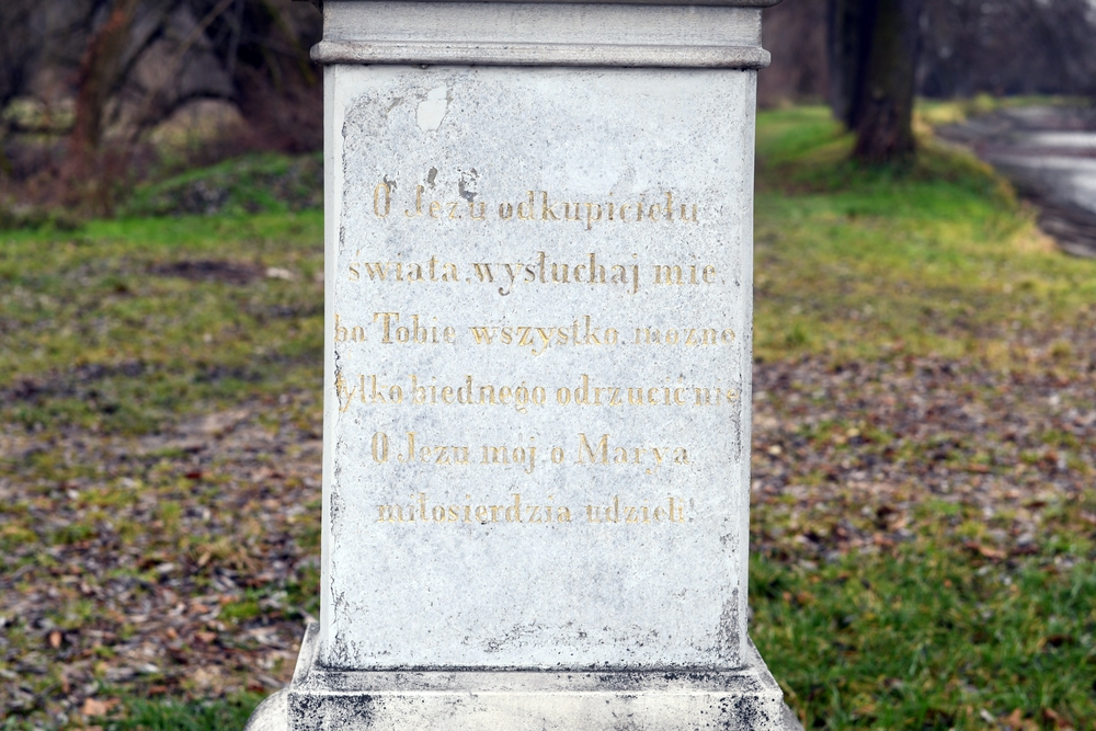 Close-up of stone plinth with inscription in Polish: 'O Jesus redeemer of the world hear me. On Thee all can be but poor rejection. O my Jesus o Marya grant mercy.'