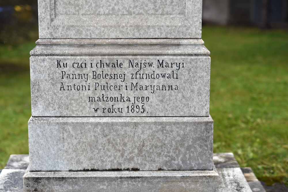 Inscription on the stone plinth: 'In honour and glory of the Blessed Virgin Mary of Sorrows, founded by Antoni Pulcer and Maryanna his wife in the year 1895.'
