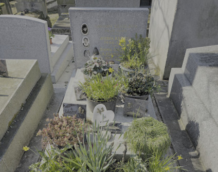 Nagrobek Józefy Krezel, Emmy Lajdanowicz i Grégory’ego Legeleux’a z cokolem schodkowym, skośną płytą i prostokątną stelą. Widoczne trzy fotografie na porcelanie i różne tabliczki z motywami religijnymi.