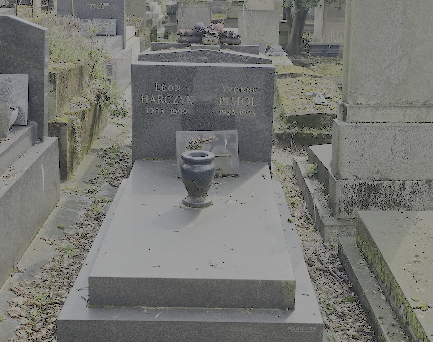 Gravestone of Leon Harczyk and Yvonne Pujol with inscriptions on a rectangular stele. A granite plaque with a sunflower motif is placed on the slab.