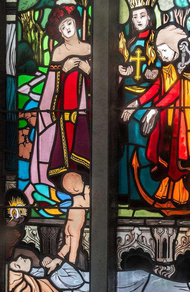 Joseph Mehoffer's stained glass window in the Grauer family chapel in Opava, depicting a scene with a woman in a red robe, a child with coloured wings and religious figures with a cross.