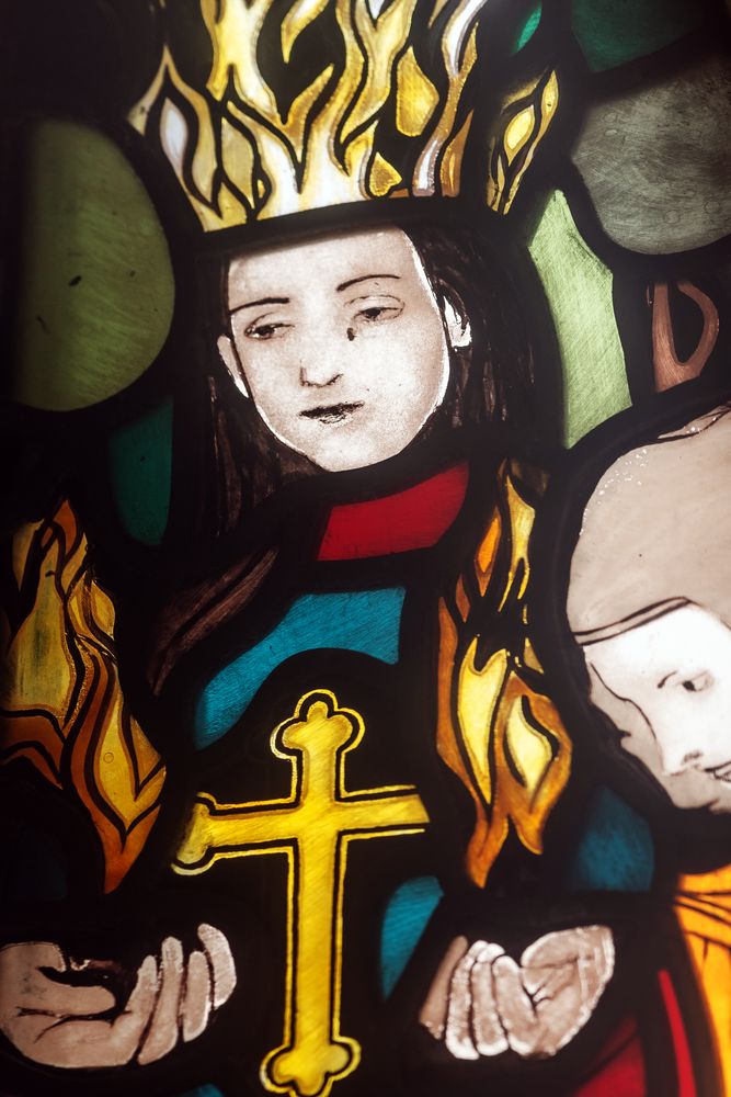 Joseph Mehoffer's stained glass window in the Grauer family chapel in Opava, depicting a figure with a crown of flames, a yellow cross and vivid colours such as red, blue and green.