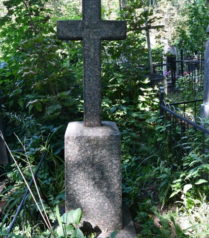 Nagrobek z krzyżem na cokole i podstawie, z mniejszym krzyżem wyrytym na przecięciu ramion. Cokół ma ścięte górne krawędzie i inskrypcję z przodu.