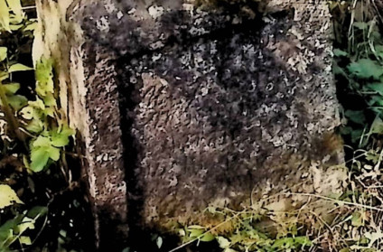 Kamienny cokół grobu lekko zwężający się ku górze, z ściętymi krawędziami. Z przodu płycina z rytą inskrypcją. Otoczony zielenią.