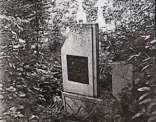 Nagrobek Jana Baryłki z stelą na cokole. Stela ma ścięty lewy górny narożnik i tablicę inskrypcyjną. Cokół zdobiony geometrycznymi wzorami.