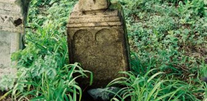 Nagrobek Anny Blońskiej z krzyżem na cokole. Krzyż fazowany, zdobiony symetrycznymi guzkami. Cokół z profilowanym zwieńczeniem i inskrypcją w płycinie łukowej.