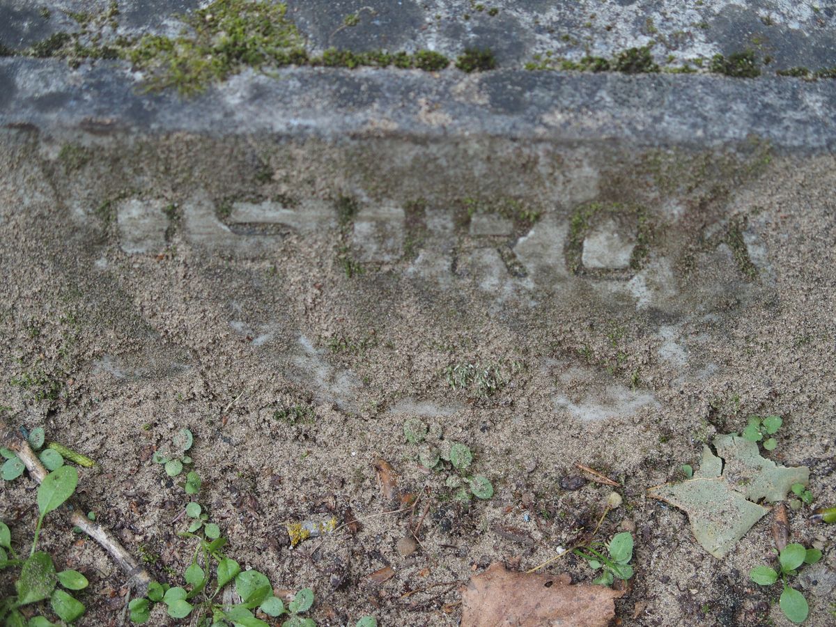Napis z nagrobka Adolfa Oszuroka, cmentarz św. Michała w Rydze, stan z 2021 r