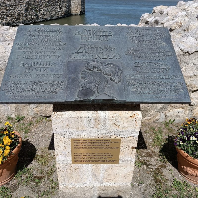 Plaque commemorating Zawisza Czarny at Golubac Fortress in Serbia, featuring his image and text in Polish and Serbian honoring his bravery and death in 1428.