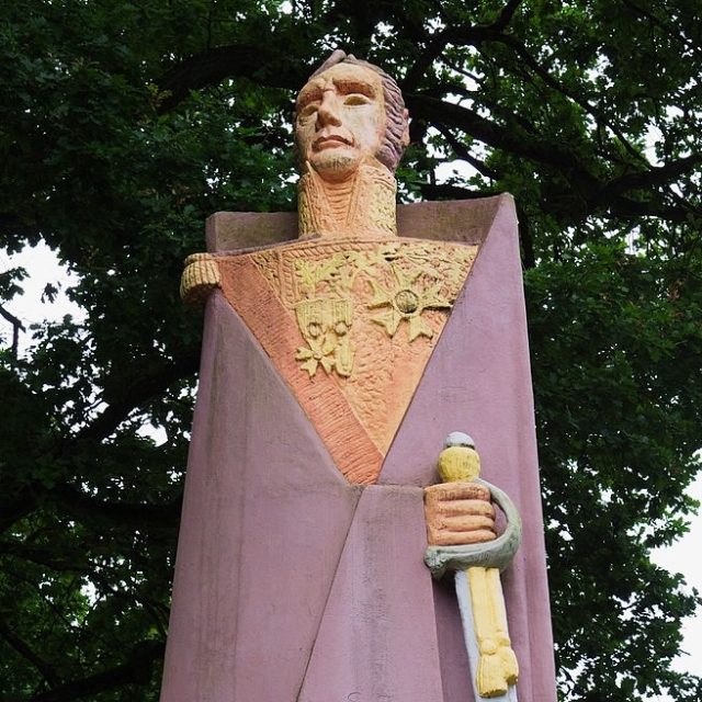 Statue of Marshal Michel Ney by Jan Lambert-Rucki in Saarlouis, depicting a stylized figure with a simplified form, holding a sword, against a backdrop of trees.