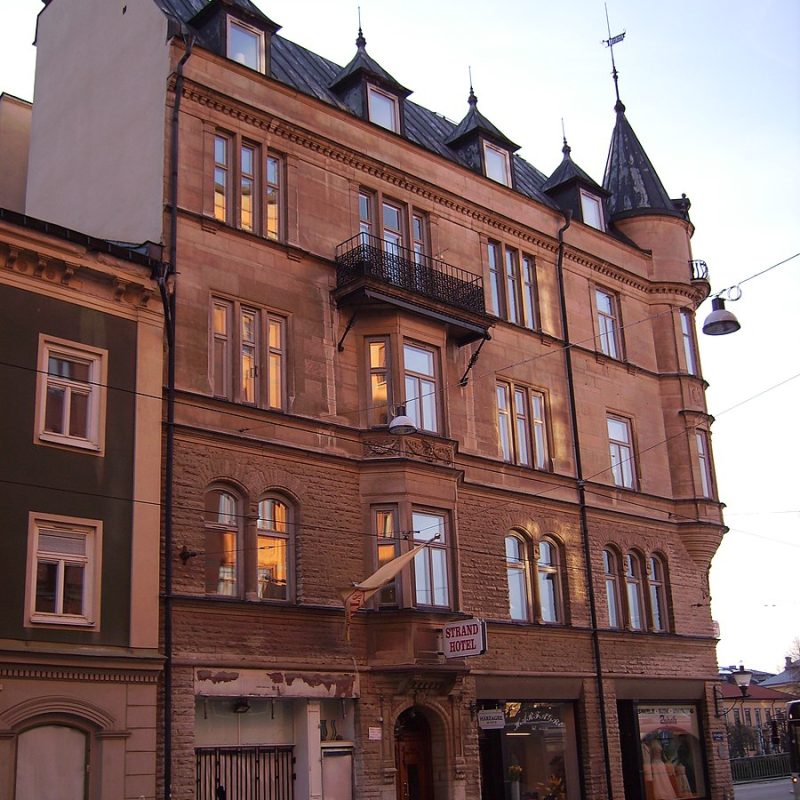 Facade of the Ławski tenement house in Norrköping, Sweden, built in 1897. The building features a relief of the Kingdom of Poland's coat of arms on the second floor and currently houses the Strand Hotel.
