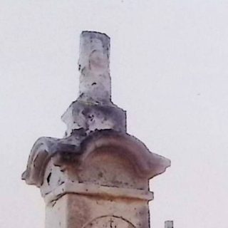 Gravestone of Jan and Franciszka Zombrowski with a broken cross on a two-tier pedestal. The cross features Christ and an INRI inscription. Palm leaves and an engraved inscription are visible.