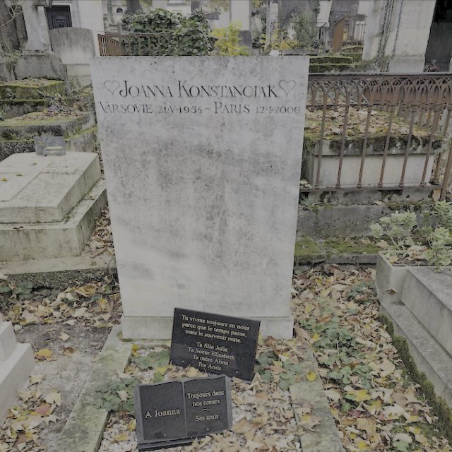 Gravestone of Alina and Joanna Konstanciak with a high rectangular stele on a low pedestal. Inscriptions on the stele and three plaques on the stone-filled frame.