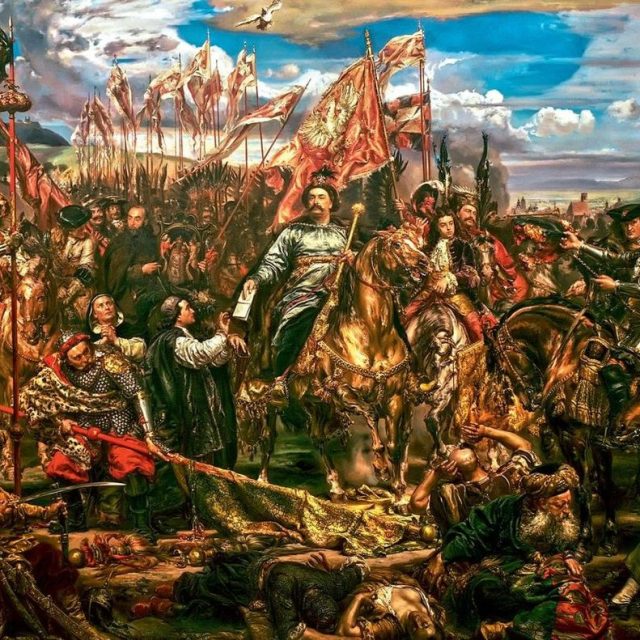 Peinture historique représentant une scène de bataille avec une figure centrale à cheval, entourée de soldats et de drapeaux. Un arc-en-ciel surplombe la scène, ajoutant un effet dramatique.