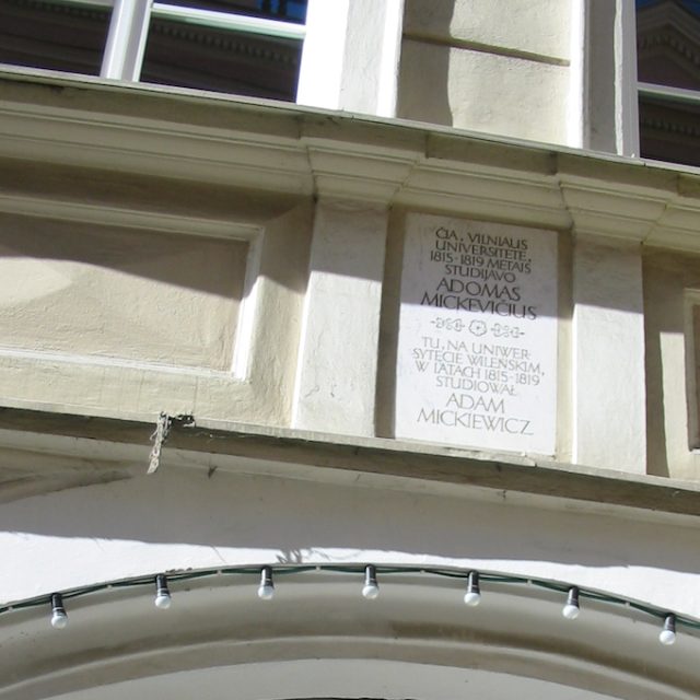 Commemorative plaque for Adam Mickiewicz's studies at Vilnius University, located on the facade of the university building. The plaque includes text in Polish and Lithuanian.