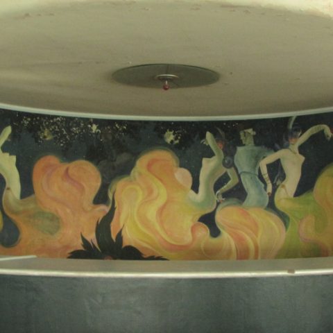 A mural by Stefan Norblin at Morvi Palace in India, depicting abstract human figures amidst swirling flames in the Art Deco style.