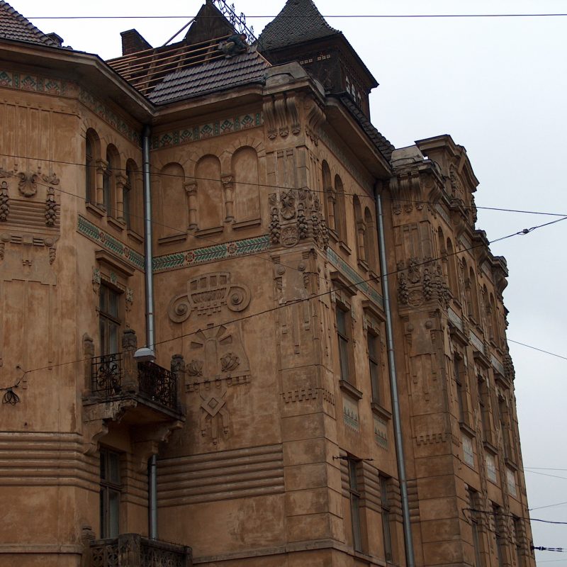 Art Nouveau building of the Dnister Insurance Company at 20 Ruska Street. Features ornate facade with majolica tiles, decorative reliefs, and arched windows.