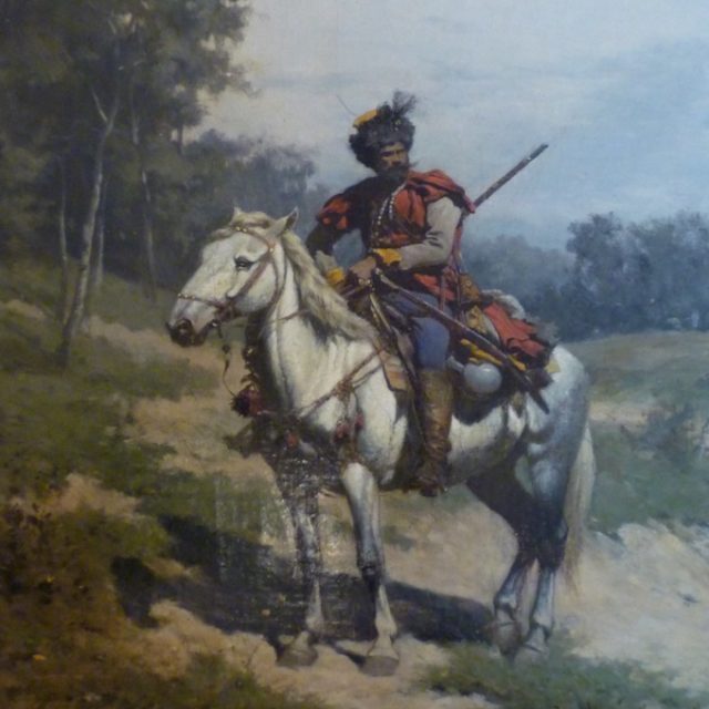 A painting of a guard on horseback by Władysław Szerner. The guard, wearing a red uniform, sits on a white horse in a natural landscape featuring trees and a cloudy sky.